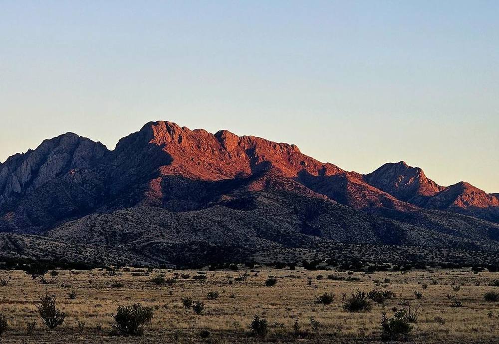 Alpenglow on the mountains above the high desert at sunset