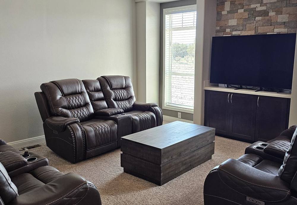 Lodge great room with leather recliners and a wall-mounted television