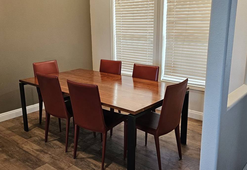 Lodge dining room with a wood table and six chairs beside a window