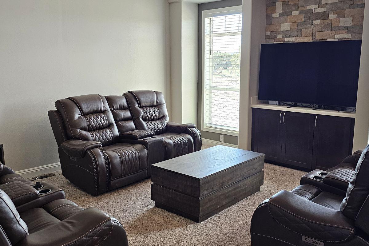 Second lodge sitting area with recliners arranged around a low table