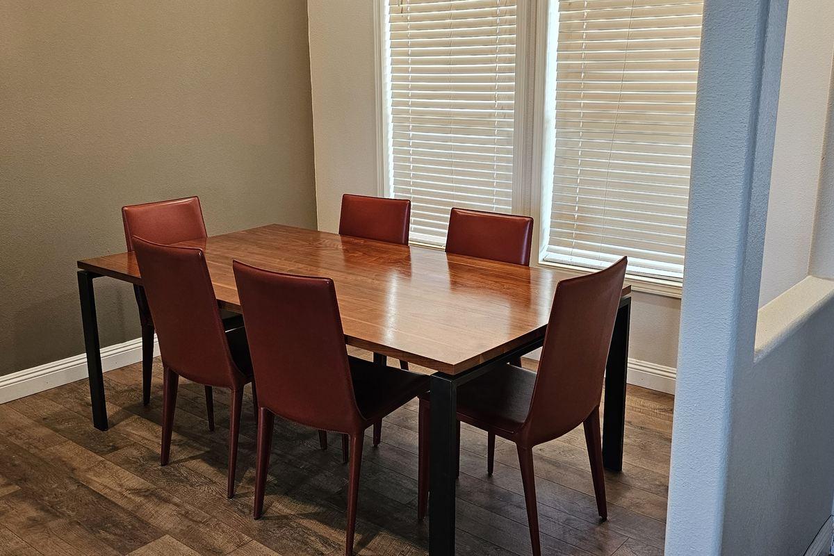 Lodge dining room with a wood table and six chairs beside a window